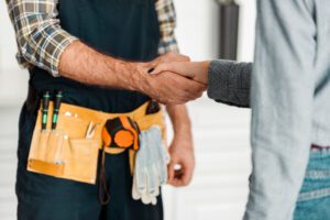 Shaking hand to a plumber. Home services marketing concept