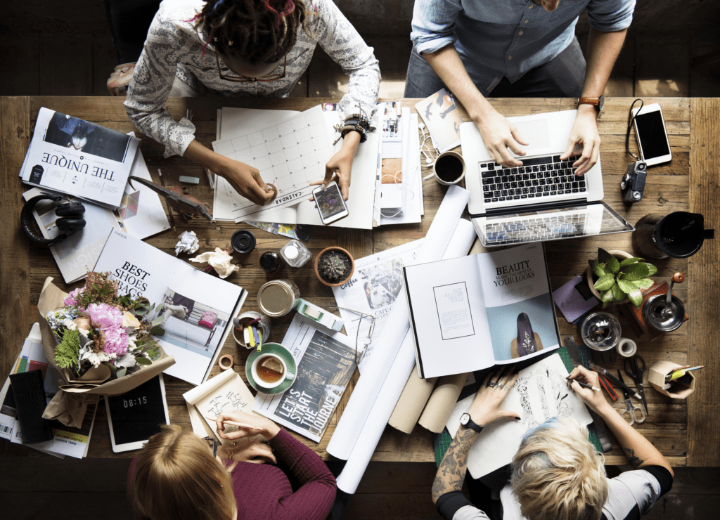 A group of marketing agency experts sitting and working together at a desk.