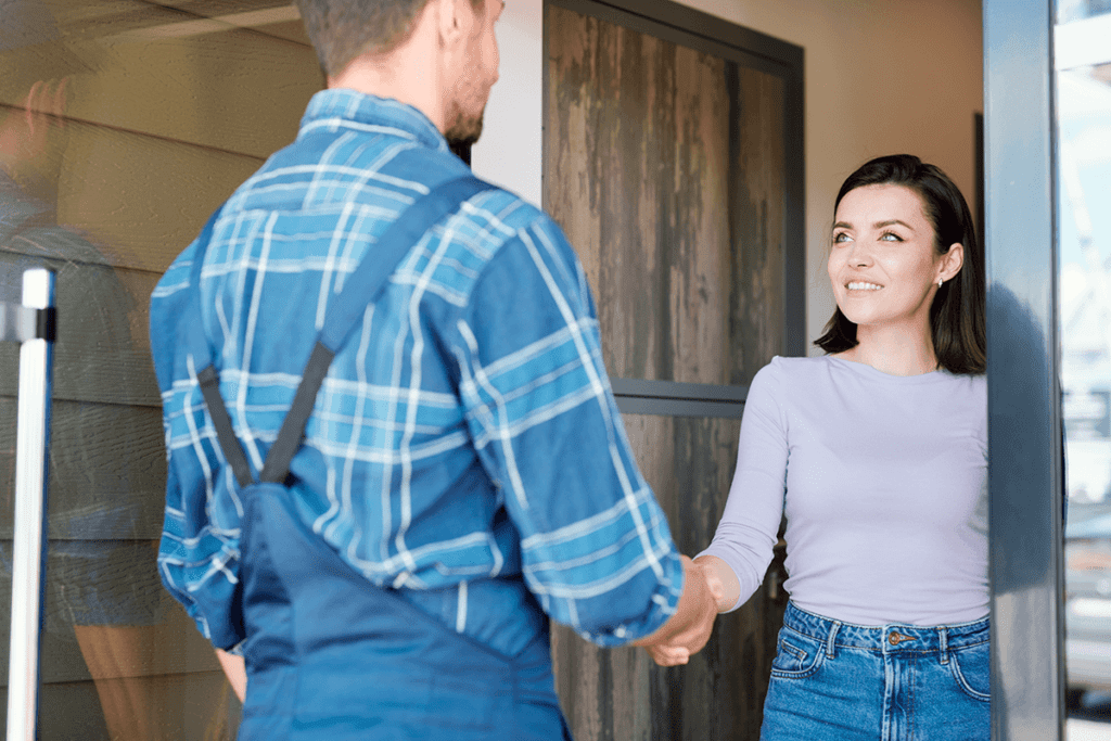 Handyman shaking hands with his client